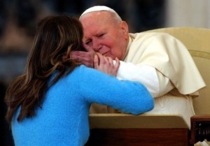 Paula Olearnik of Poland embraces Pope John Paul II during a celebration with young people in St. Peter's Square at the Vatican April 1. Tens of thousands of youths responded to the pope, who asked them to "live as true Christians." (CNS photo by Giancarlo Giuliani, Catholic Press Photo) (April 2, 2004) See POPE-CROSS April 2, 2004.